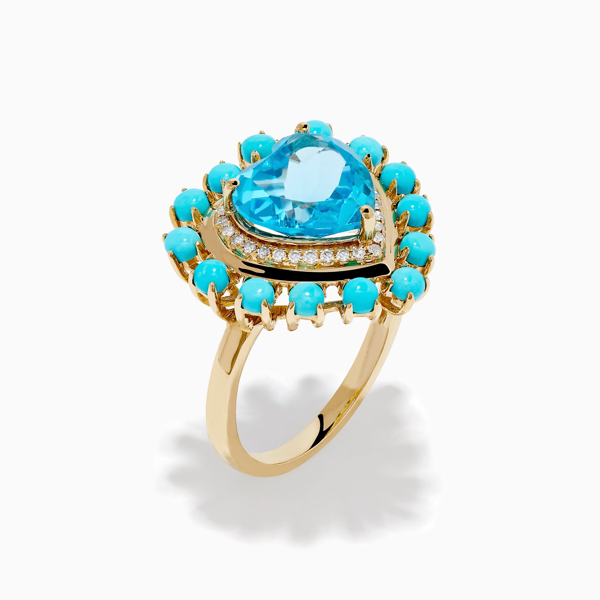 The 14K Yellow Gold Blue Topaz, Turquoise and Diamond Heart Cocktail Ring features a striking heart-shaped blue topaz center, surrounded by a halo of diamonds and an outer border of vibrant round turquoise stones.