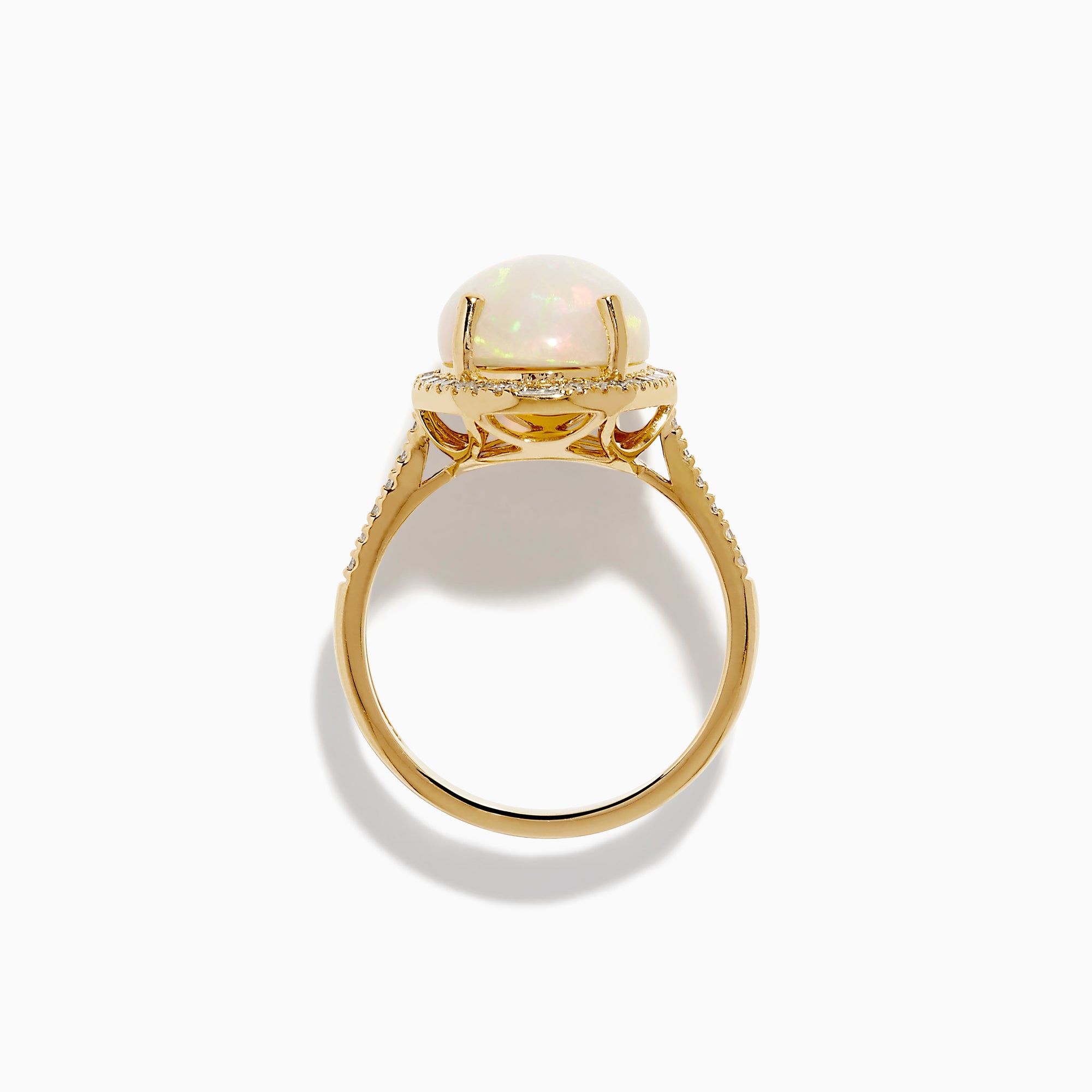 The 14K Yellow Gold Opal and Diamond Halo Cocktail Ring showcases an oval opal centerpiece encircled by a shimmering diamond halo, set against a white background.