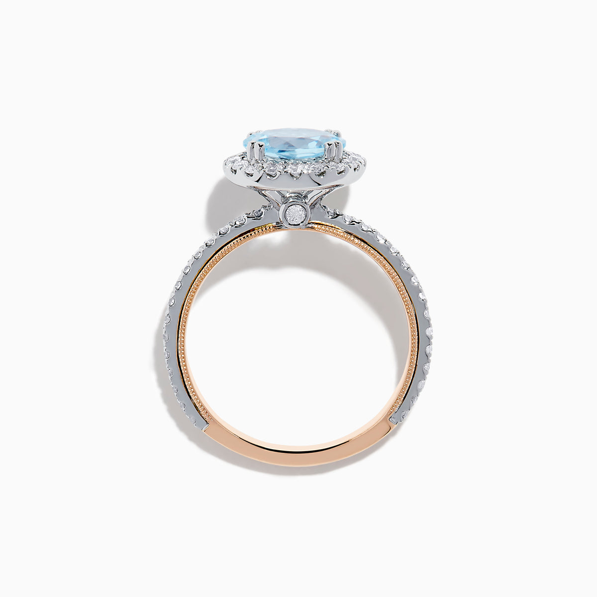The Aquarius 14K Rose and White Gold Aquamarine and Diamond Ring features a large round aquamarine center, surrounded by a halo of sparkling diamonds with additional diamonds along the band.