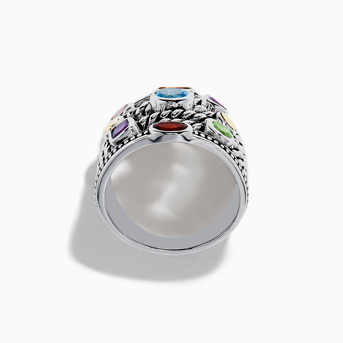 The Mosaic 925 Sterling Silver & 18K Yellow Gold Multi Color Gemstone Ring features twisted rope-style bands and seven bezel-set gemstones—blue, red, orange, yellow, purple, and green—encircling the wide ring.