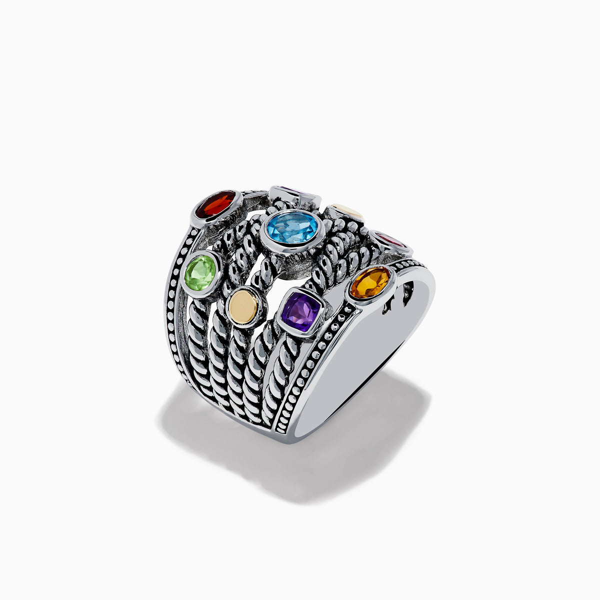 The Mosaic 925 Sterling Silver & 18K Yellow Gold Multi Color Gemstone Ring features twisted rope-style bands and seven bezel-set gemstones—blue, red, orange, yellow, purple, and green—encircling the wide ring.