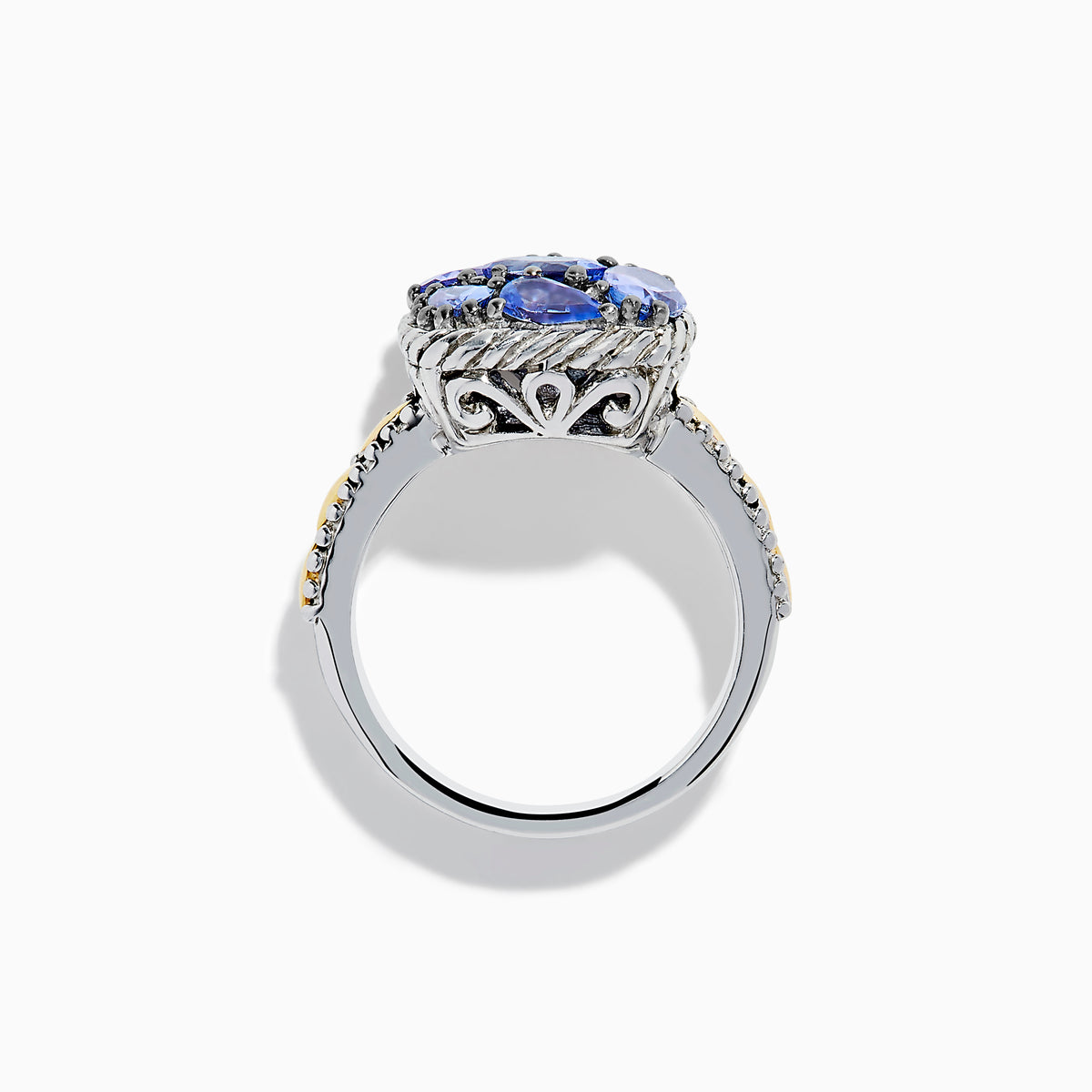 The 925 Sterling Silver and 18K Yellow Gold Tanzanite Ring features intricate rope detailing and a cluster of five marquise and oval blue gemstones, highlighted by yellow gold accents along the band.