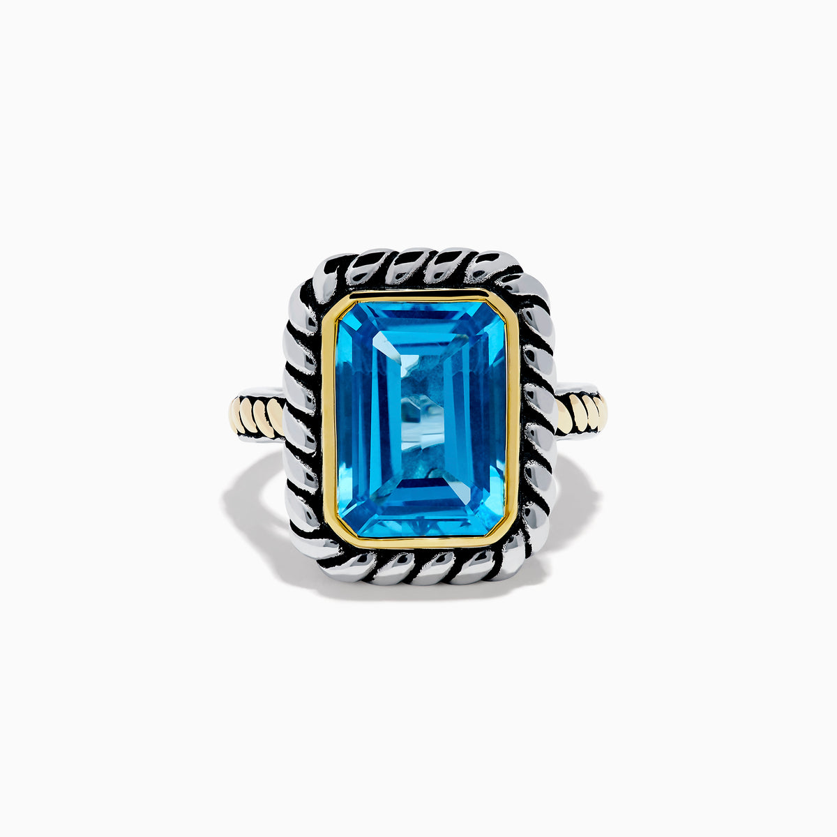 The 925 Sterling Silver and 18K Yellow Gold Blue Topaz Ring features an emerald-cut rectangular blue topaz in a twisted bezel setting with a rope-textured band, shown on a white background.