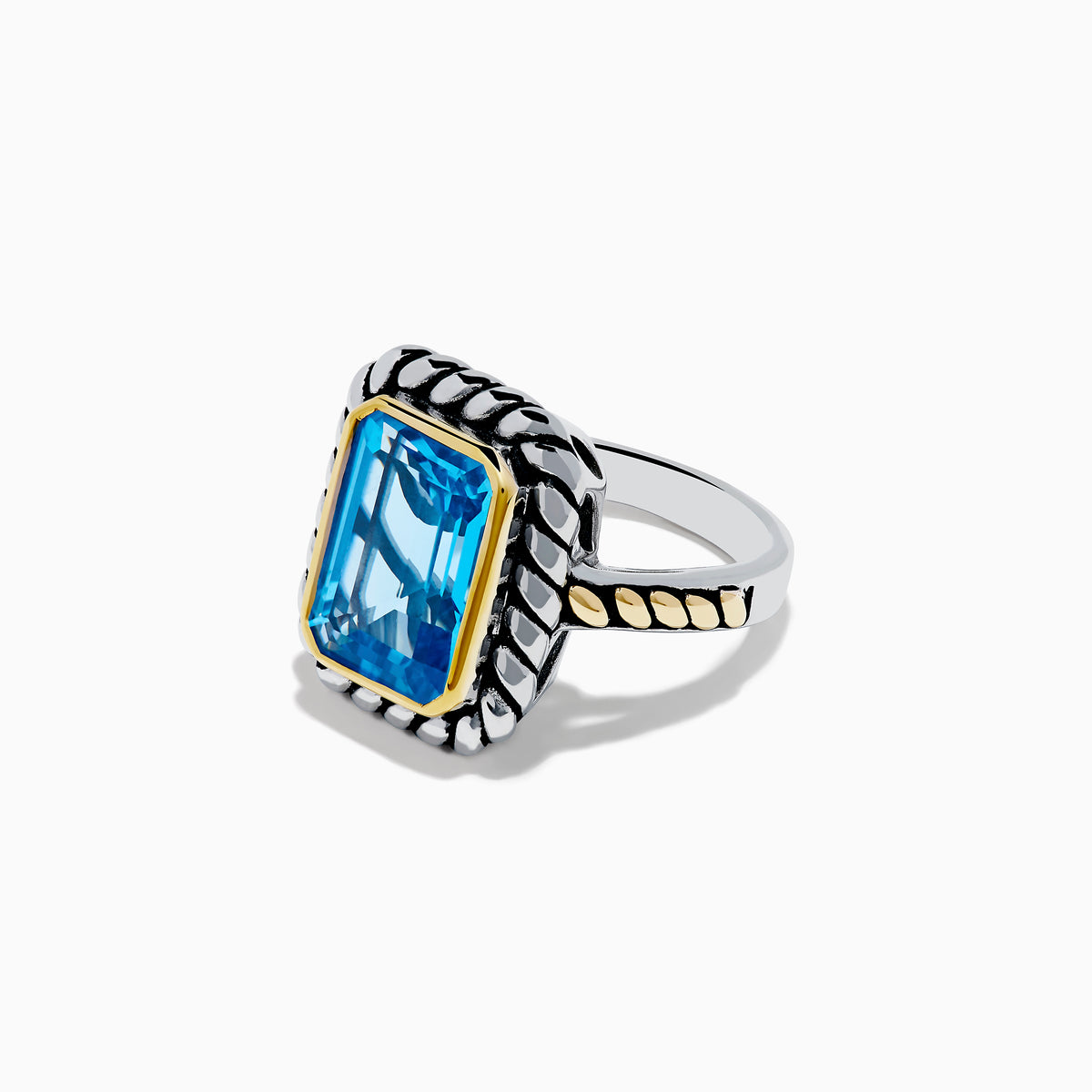 The 925 Sterling Silver and 18K Yellow Gold Blue Topaz Ring features an emerald-cut rectangular blue topaz in a twisted bezel setting with a rope-textured band, shown on a white background.