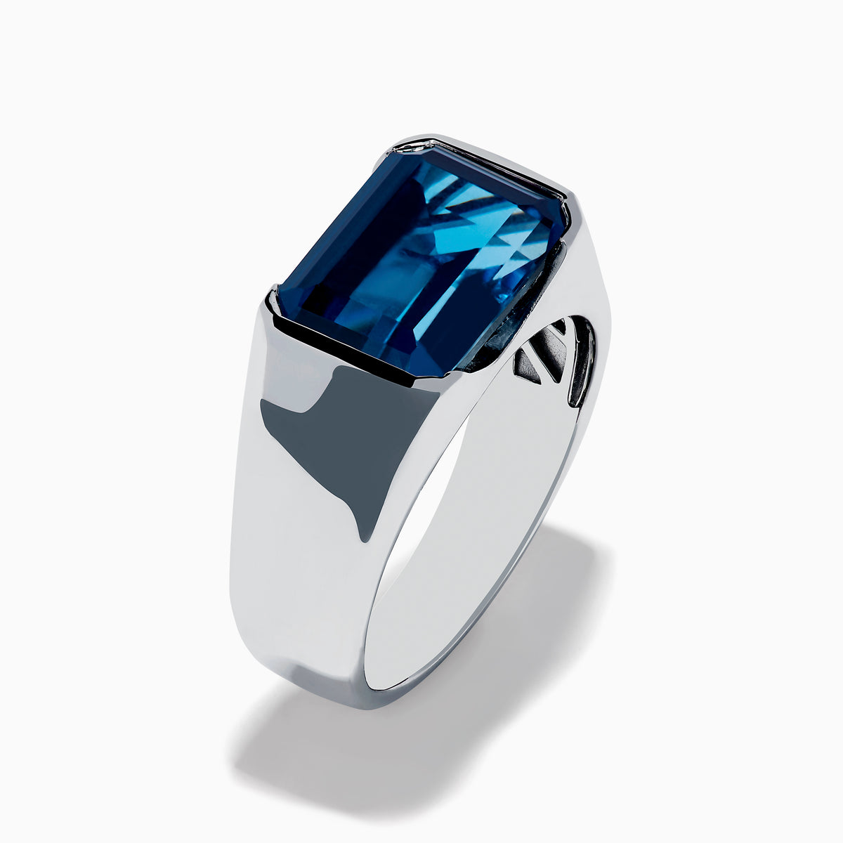 The Mens Ocean Bleu 925 Sterling Silver London Blue Topaz Ring features a large, emerald-cut rectangular gemstone set in the center, showcased against a plain white background.