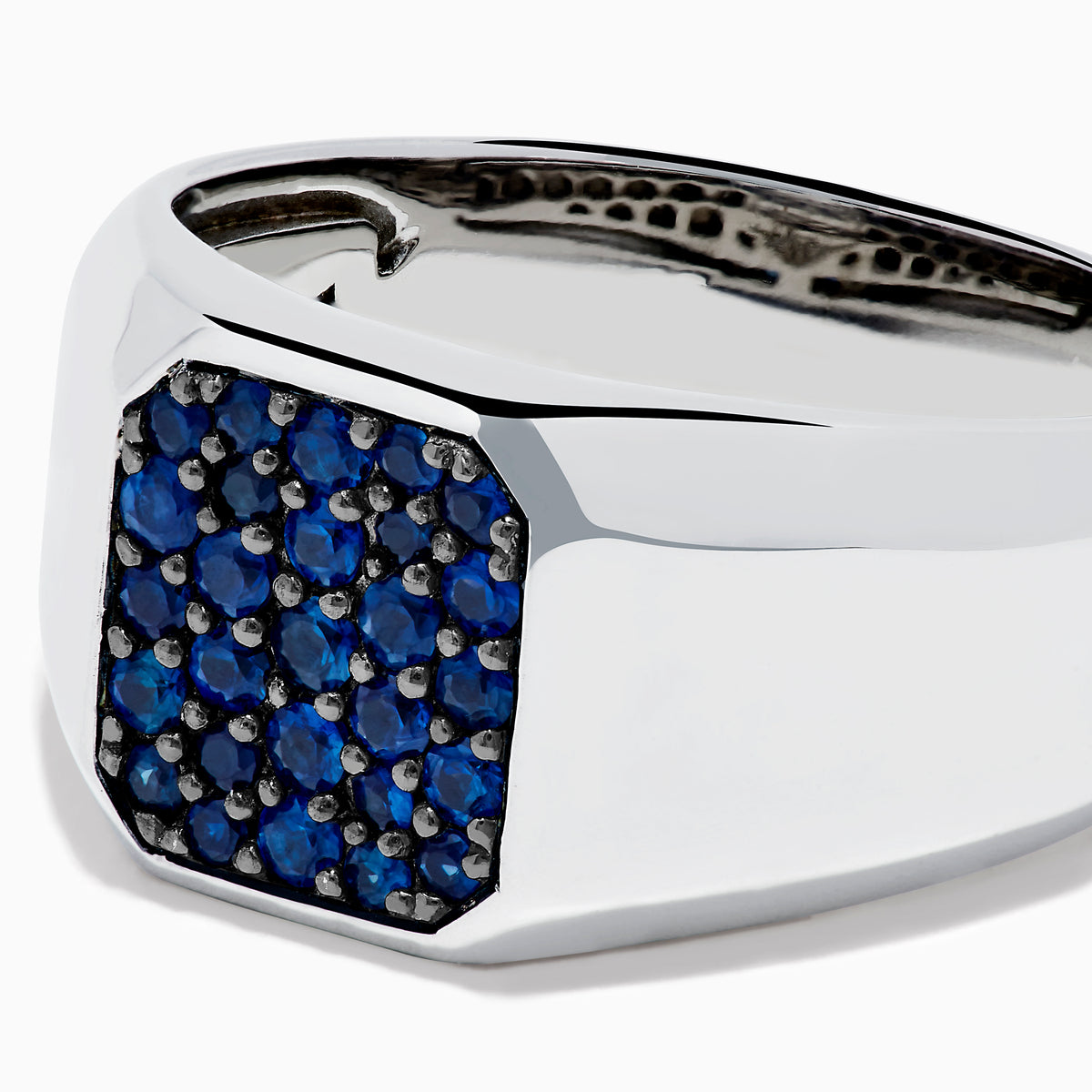 The Men's 925 Sterling Silver Blue Sapphire Signet-style Ring features a rectangular face adorned with small round blue sapphires in a grid pattern, shown on a white background.