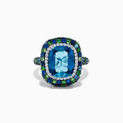 The 925 Sterling Silver Blue Topaz Cushion Multi Gemstone Halo Ring features a large rectangular blue topaz center, encircled by a halo of small white, green, and blue stones.