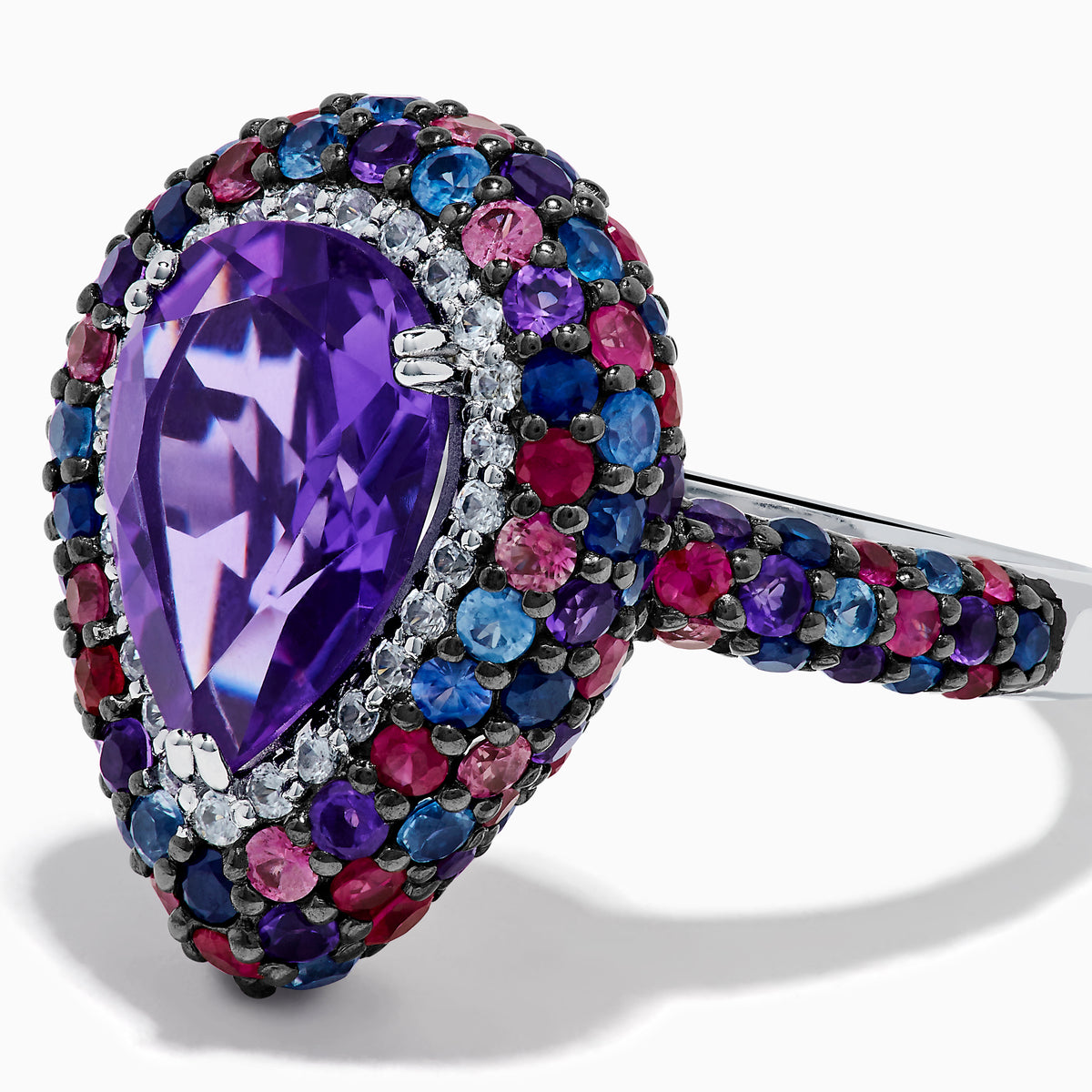 The 925 Sterling Silver Amethyst Pear Multi Gemstone Halo Ring features a pear-shaped amethyst surrounded by a pavé band with blue, pink, and red stones, creating a vibrant halo effect around the center gem.