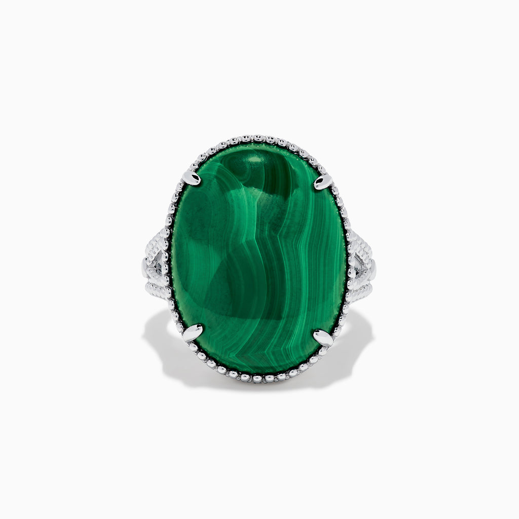 The 925 Sterling Silver Malachite Oval Ring showcases a large, oval green malachite stone with natural banding, set in four prongs and finished with decorative bead accents for a striking look.