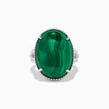 The 925 Sterling Silver Malachite Oval Ring showcases a large, oval green malachite stone with natural banding, set in four prongs and finished with decorative bead accents for a striking look.