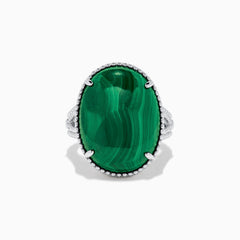 The 925 Sterling Silver Malachite Oval Ring showcases a large, oval green malachite stone with natural banding, set in four prongs and finished with decorative bead accents for a striking look.