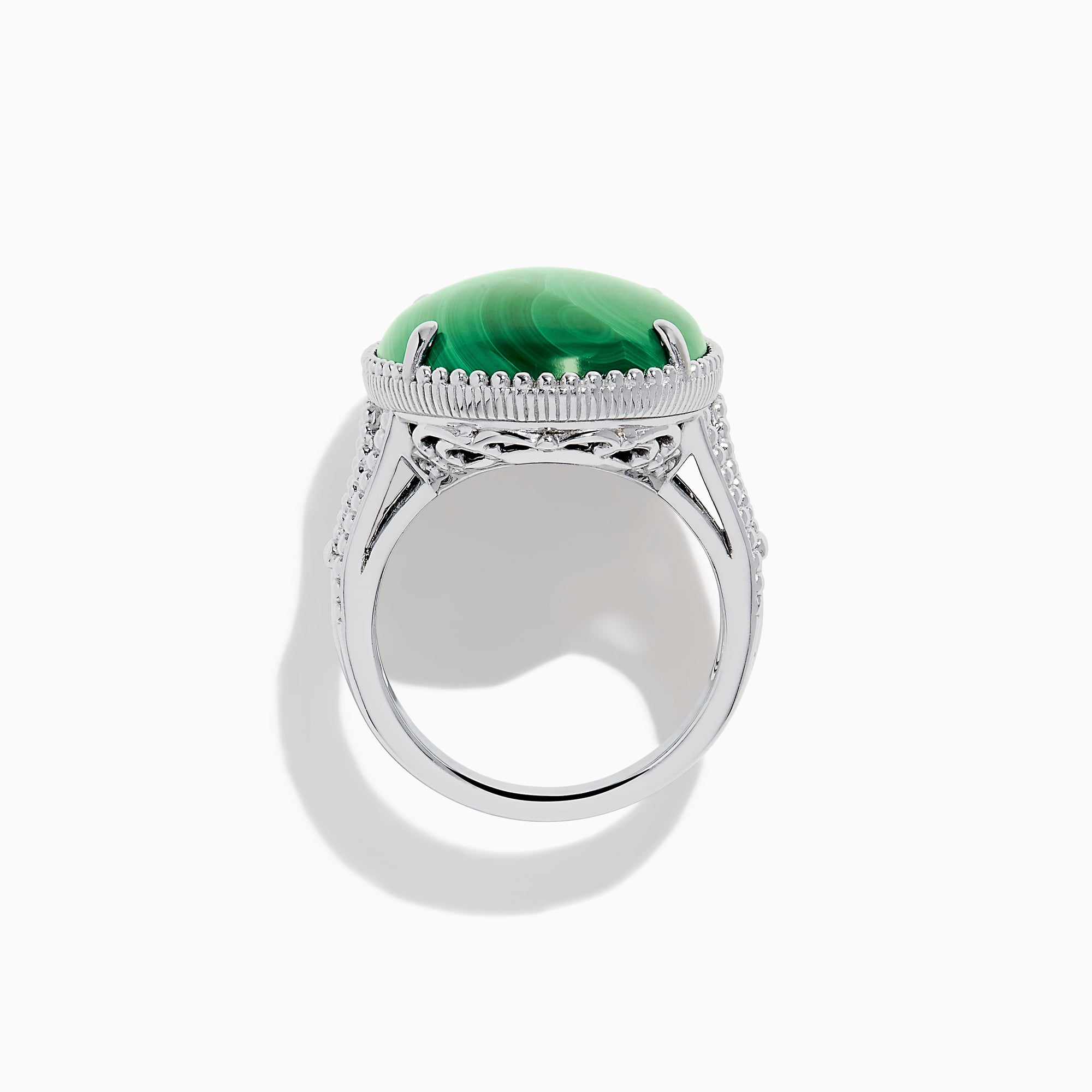The 925 Sterling Silver Malachite Oval Ring showcases a large, oval green malachite stone with natural banding, set in four prongs and finished with decorative bead accents for a striking look.