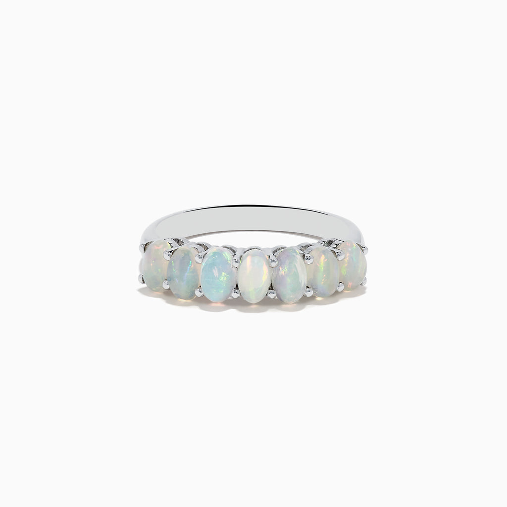The Aurora 925 Sterling Silver Opal Ring showcases seven oval opals with iridescent hues, set closely on a sleek sterling silver band.