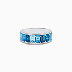 The Ocean Bleu 925 Sterling Silver Blue Topaz Ring features a continuous band of rectangular blue topaz gemstones in varying shades, set side by side, and is displayed against a plain white background.