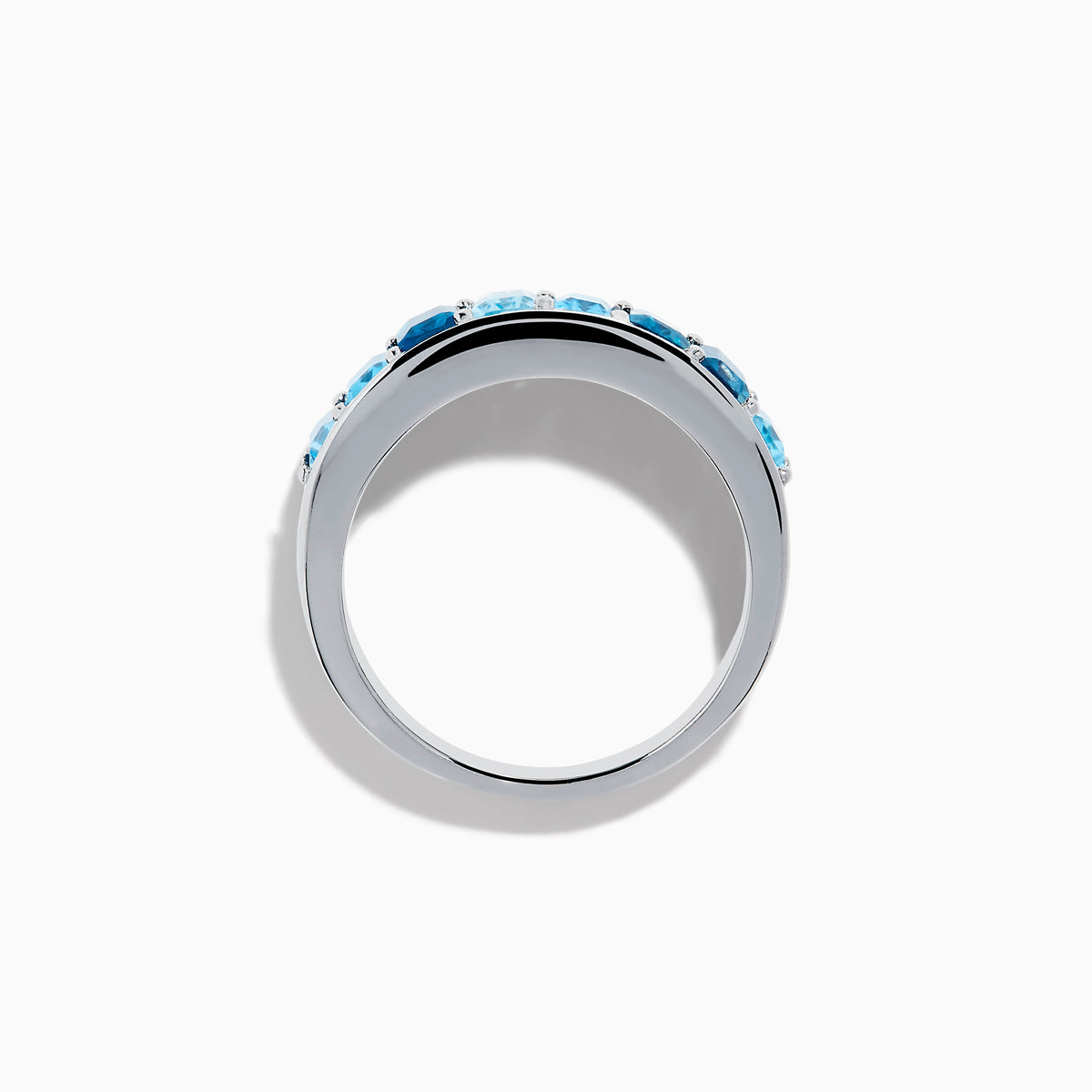 The Ocean Bleu 925 Sterling Silver Blue Topaz Ring features a continuous band of rectangular blue topaz gemstones in varying shades, set side by side, and is displayed against a plain white background.