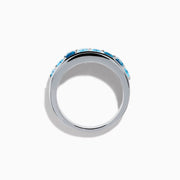 The Ocean Bleu 925 Sterling Silver Blue Topaz Ring features a continuous band of rectangular blue topaz gemstones in varying shades, set side by side, and is displayed against a plain white background.
