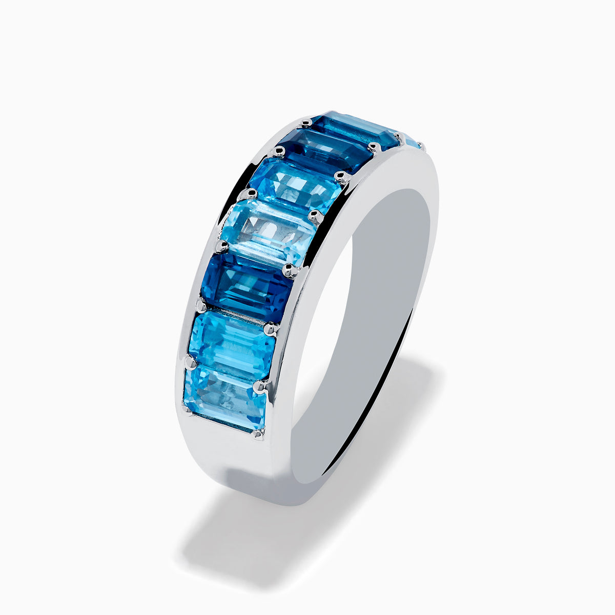 The Ocean Bleu 925 Sterling Silver Blue Topaz Ring features a continuous band of rectangular blue topaz gemstones in varying shades, set side by side, and is displayed against a plain white background.