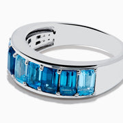 The Ocean Bleu 925 Sterling Silver Blue Topaz Ring features a continuous band of rectangular blue topaz gemstones in varying shades, set side by side, and is displayed against a plain white background.