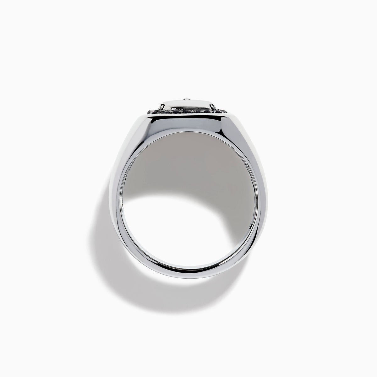 The Men's Sterling Silver Black Spinel Skull Ring features a central raised skull, small black spinel stones surrounding it, and circular engraved symbols on each side of the band.