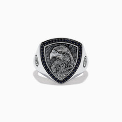 The Mens 925 Sterling Silver Black Spinel Eagle Shield Ring features an engraved eagle head on a shield-shaped face, accented with black spinel and detailed feather patterns on the eagle.