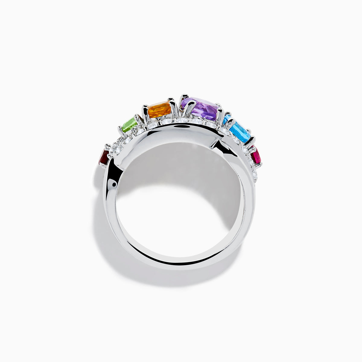 The Mosaic 925 Sterling Silver Multi Color Gemstone Ring features a row of red, green, yellow, purple, and blue gemstones accented by clear stones surrounding the band.
