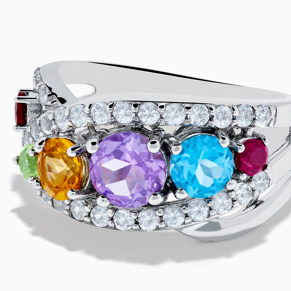 The Mosaic 925 Sterling Silver Multi Color Gemstone Ring features a row of red, green, yellow, purple, and blue gemstones accented by clear stones surrounding the band.