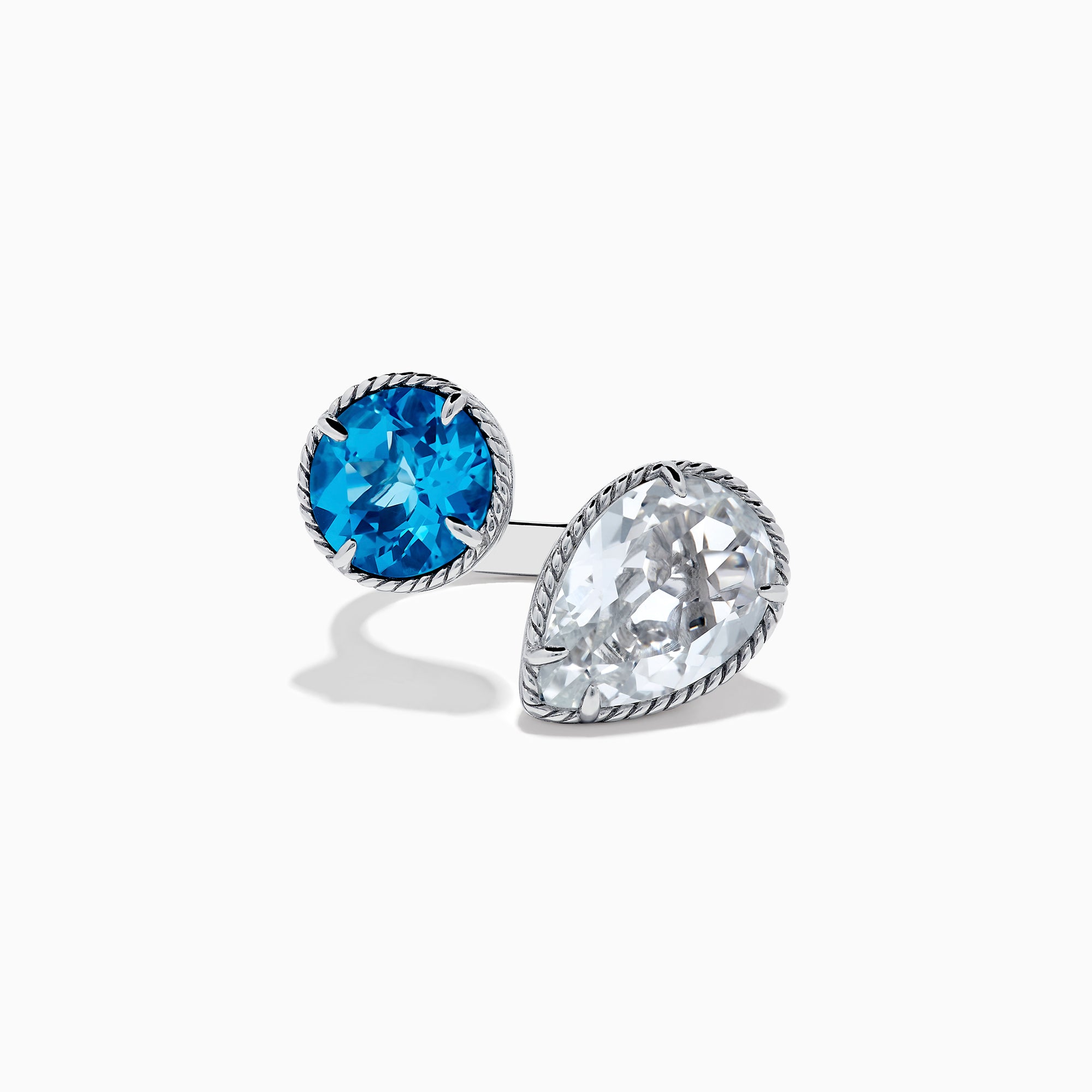 The 925 Sterling Silver Blue Topaz, White Topaz Toi Et Moi Ring features a round vivid blue topaz and a pear-shaped clear white topaz set in twisted rope-like bezels against a white background.