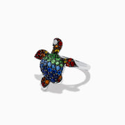 The 925 Seaside Sterling Silver Multi Sapphires Turtle Ring features a turtle design with blue, green, red, yellow, orange, and black sapphires on its shell, head, and flippers for a vibrant look.