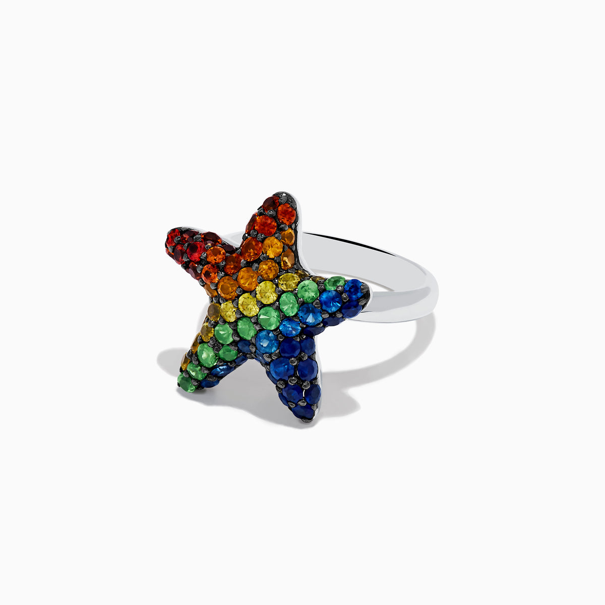 The 925 Sterling Silver Multi Color Sapphire Starfish Ring features a starfish shape adorned with vibrant rainbow sapphires.