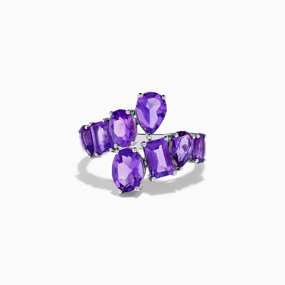 The 925 Sterling Silver Amethyst Bypass Ring showcases seven faceted purple gemstones of assorted shapes and sizes set in a sleek, modern open design against a plain white background.