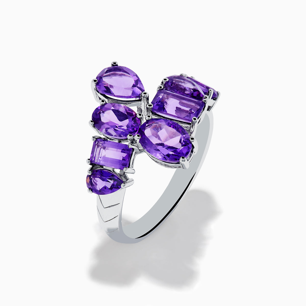 The 925 Sterling Silver Amethyst Bypass Ring showcases seven faceted purple gemstones of assorted shapes and sizes set in a sleek, modern open design against a plain white background.