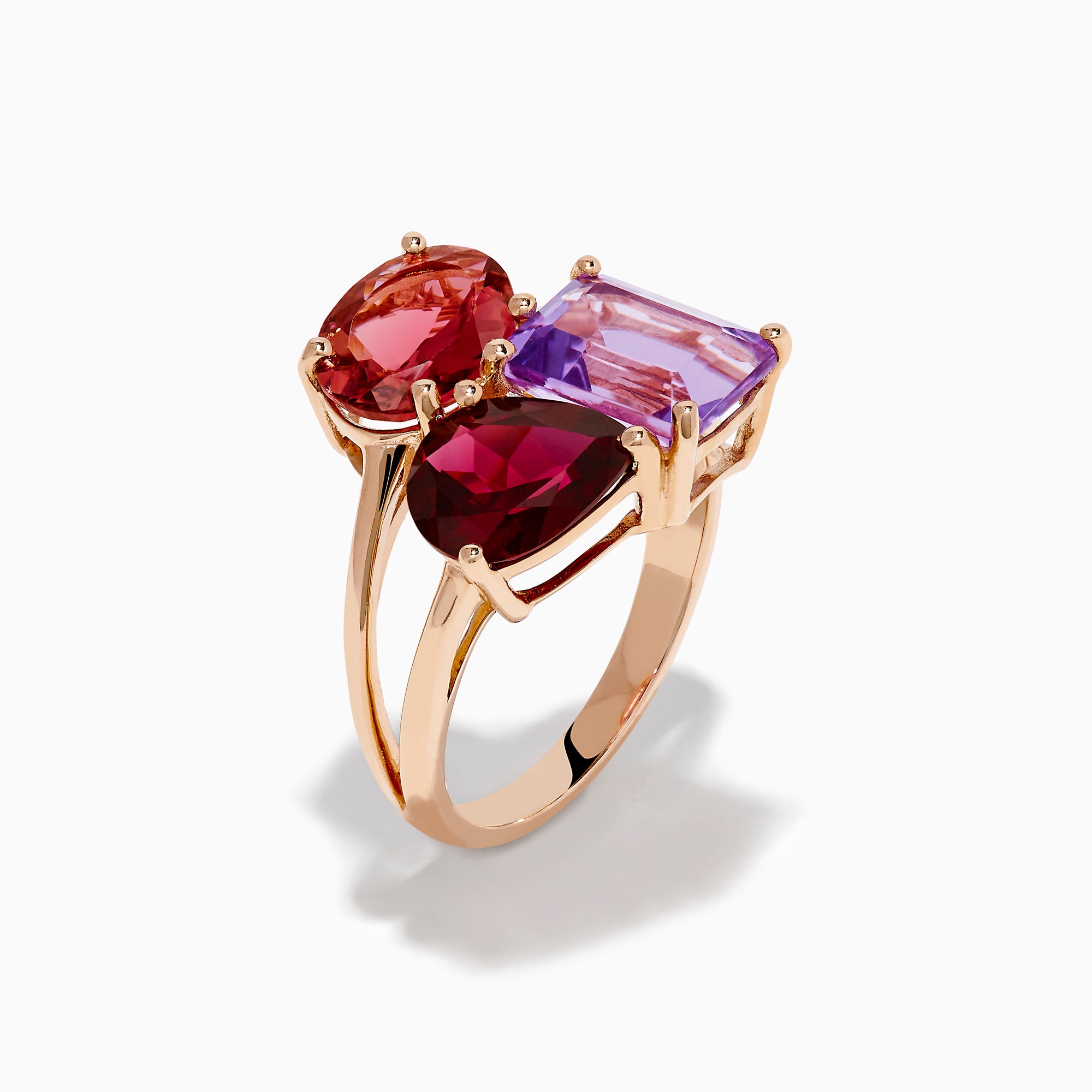 The 14K Rose Gold Pink Amethyst, Tourmaline & Rhodolite Cocktail Ring showcases a pink amethyst, deep red tourmaline, and faceted purple rhodolite in delicate prongs for a stunning cocktail look.