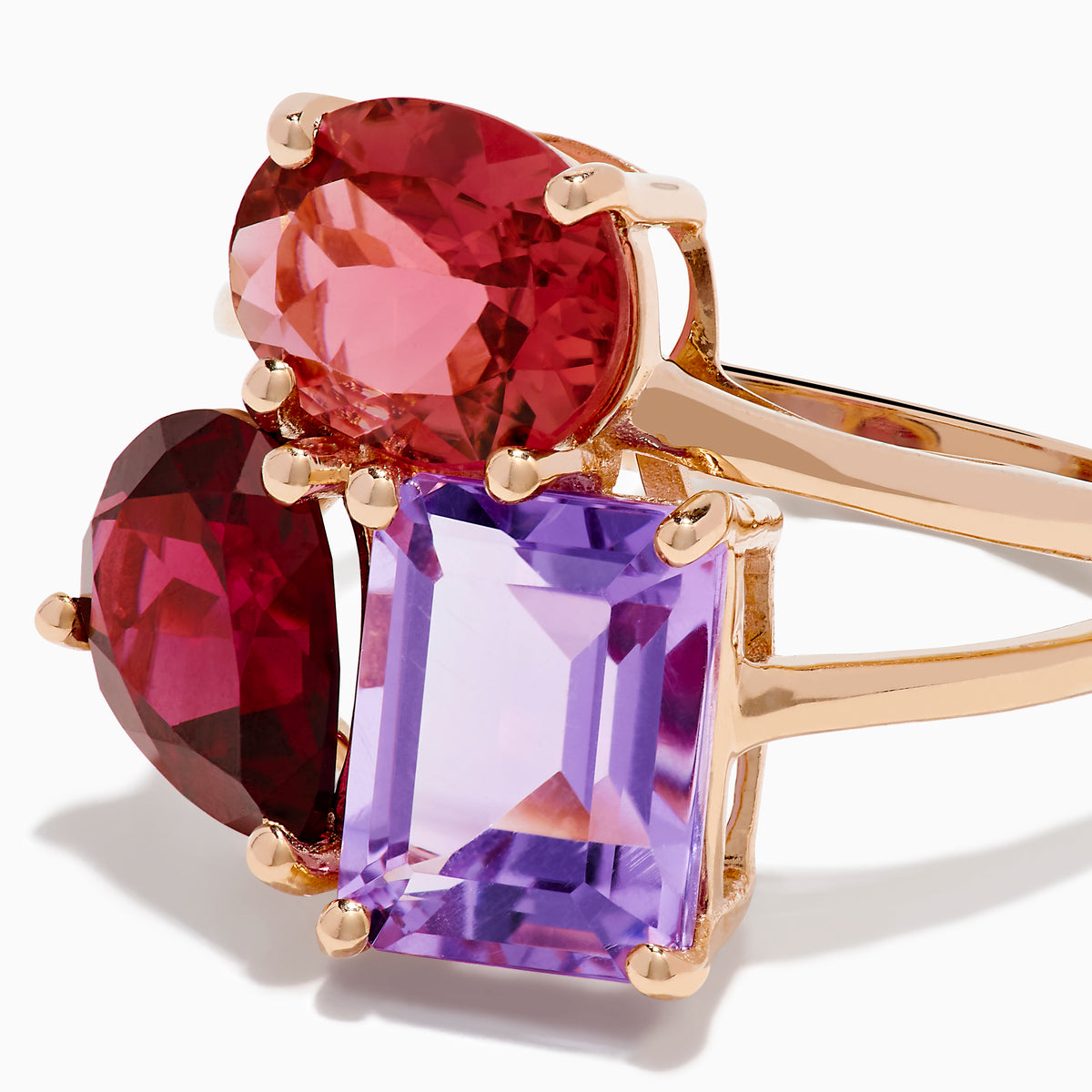 The 14K Rose Gold Pink Amethyst, Tourmaline & Rhodolite Cocktail Ring showcases a pink amethyst, deep red tourmaline, and faceted purple rhodolite in delicate prongs for a stunning cocktail look.