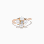 The 14K Rose Gold Fresh Water Pearl and Diamond Flower Ring features petal-shaped pearls and a central cluster of small diamonds, beautifully displayed on a white background.