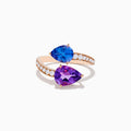 The 14K Rose Gold Amethyst, Tanzanite and Diamond Ring showcases a modern open band set with pear-shaped blue tanzanite, purple amethyst, and small round diamonds for an elegant look.