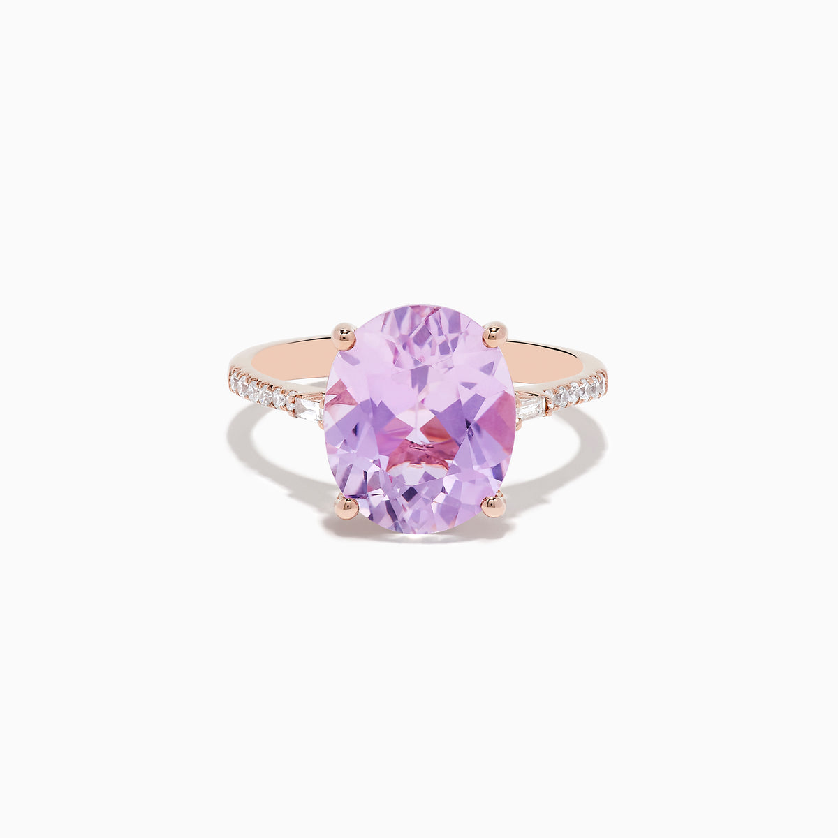 The 14K Rose Gold Kunzite and Diamond Ring features a large oval-cut kunzite center stone accented by sparkling diamonds along the band.