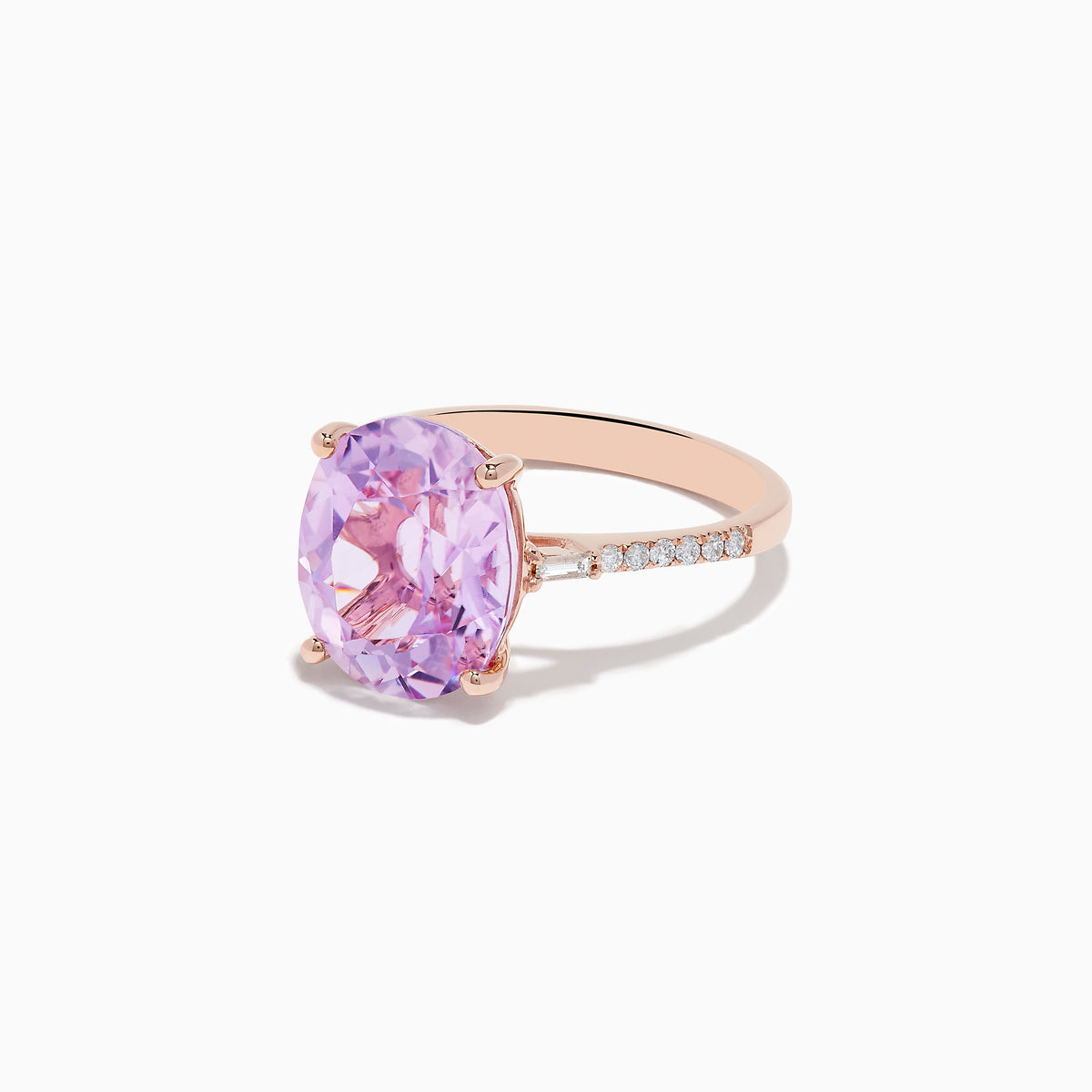 The 14K Rose Gold Kunzite and Diamond Ring features a large oval-cut kunzite center stone accented by sparkling diamonds along the band.