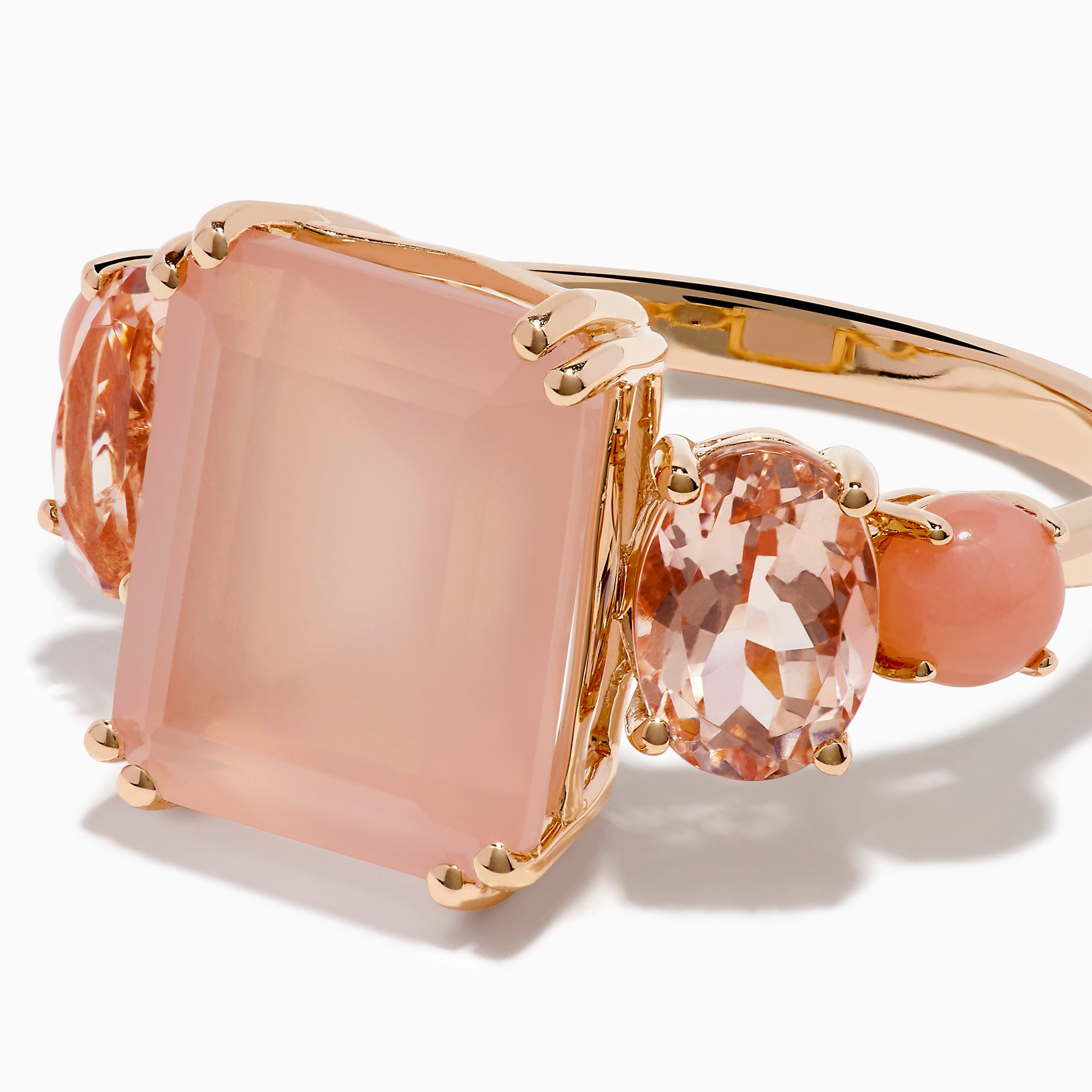 The 14K Rose Gold Pink Rose Quartz, Pink Opal and Morganite Ring features a large rectangular pink quartz center, flanked by two oval pink opals on a simple band, shown against a white background.