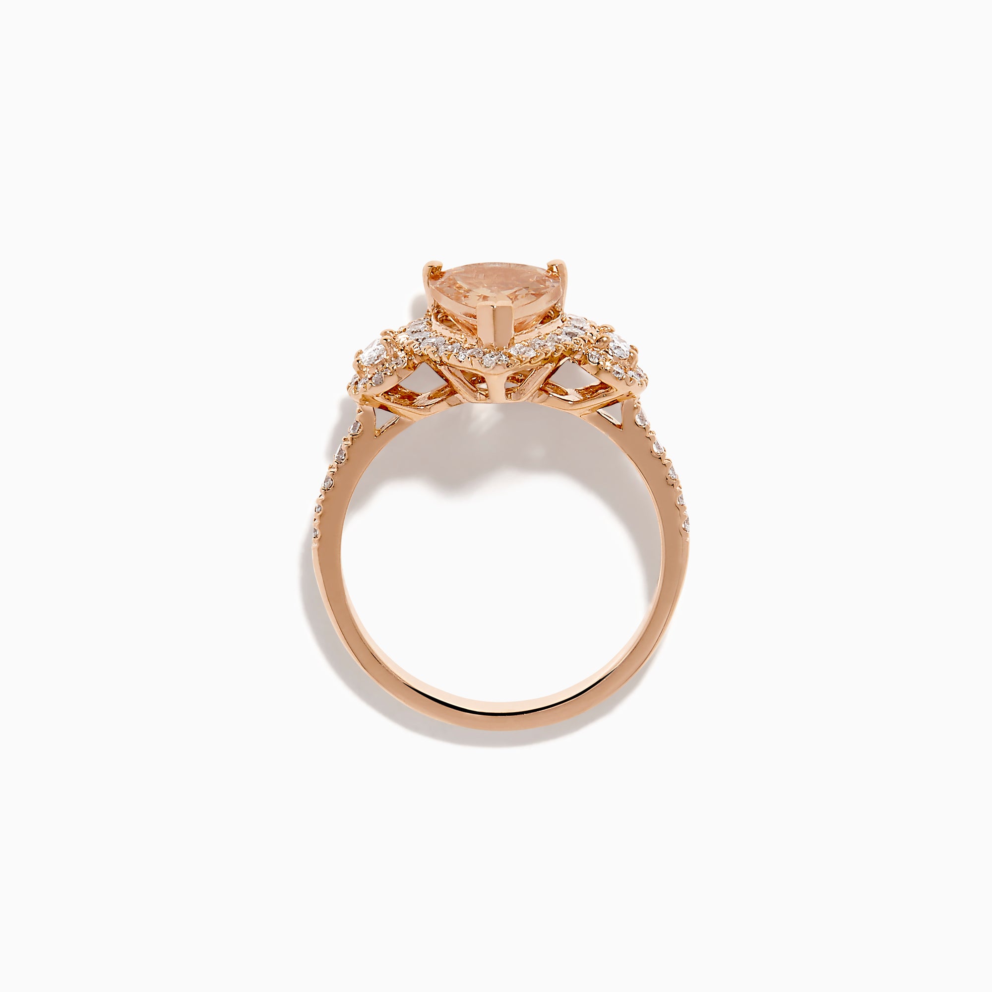 The 14K Rose Gold Pear Morganite and Diamond Halo Ring showcases a peach-hued pear morganite with sparkling diamond halo and accents, all set in 14K rose gold, against a white background.