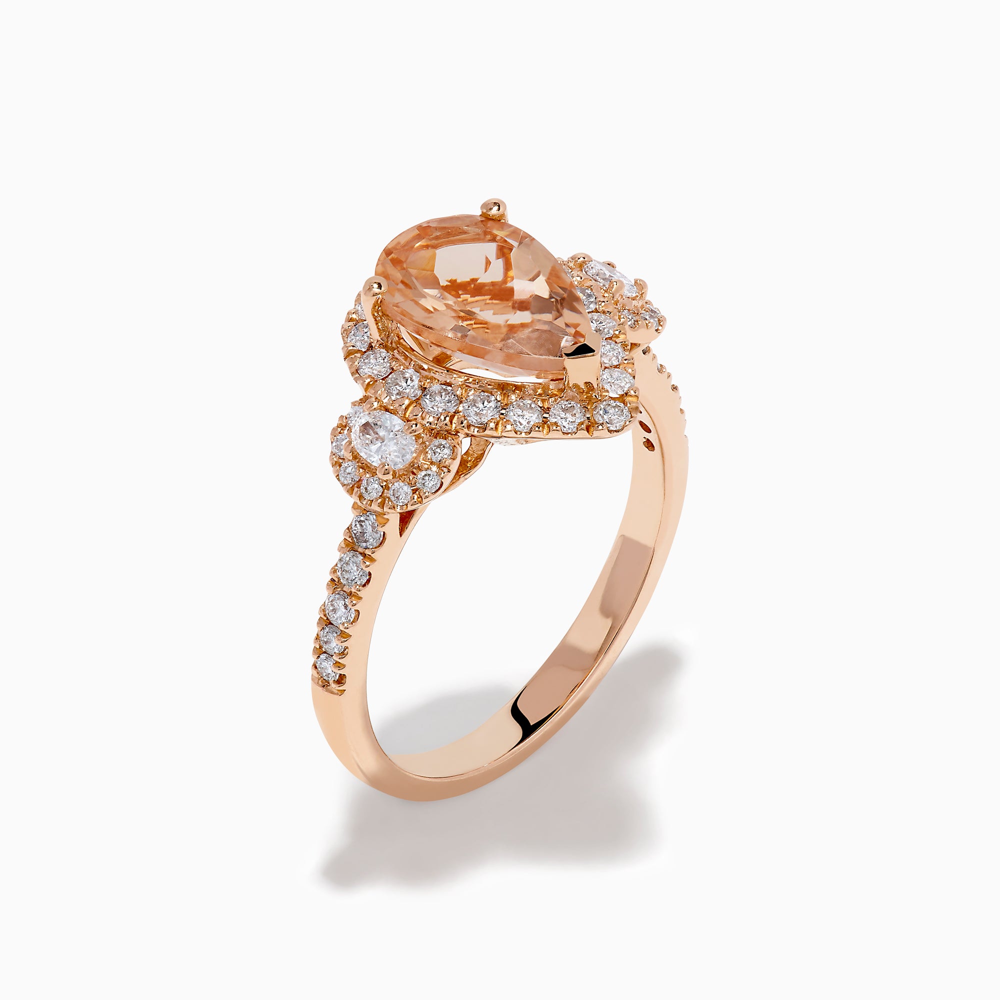 The 14K Rose Gold Pear Morganite and Diamond Halo Ring showcases a peach-hued pear morganite with sparkling diamond halo and accents, all set in 14K rose gold, against a white background.