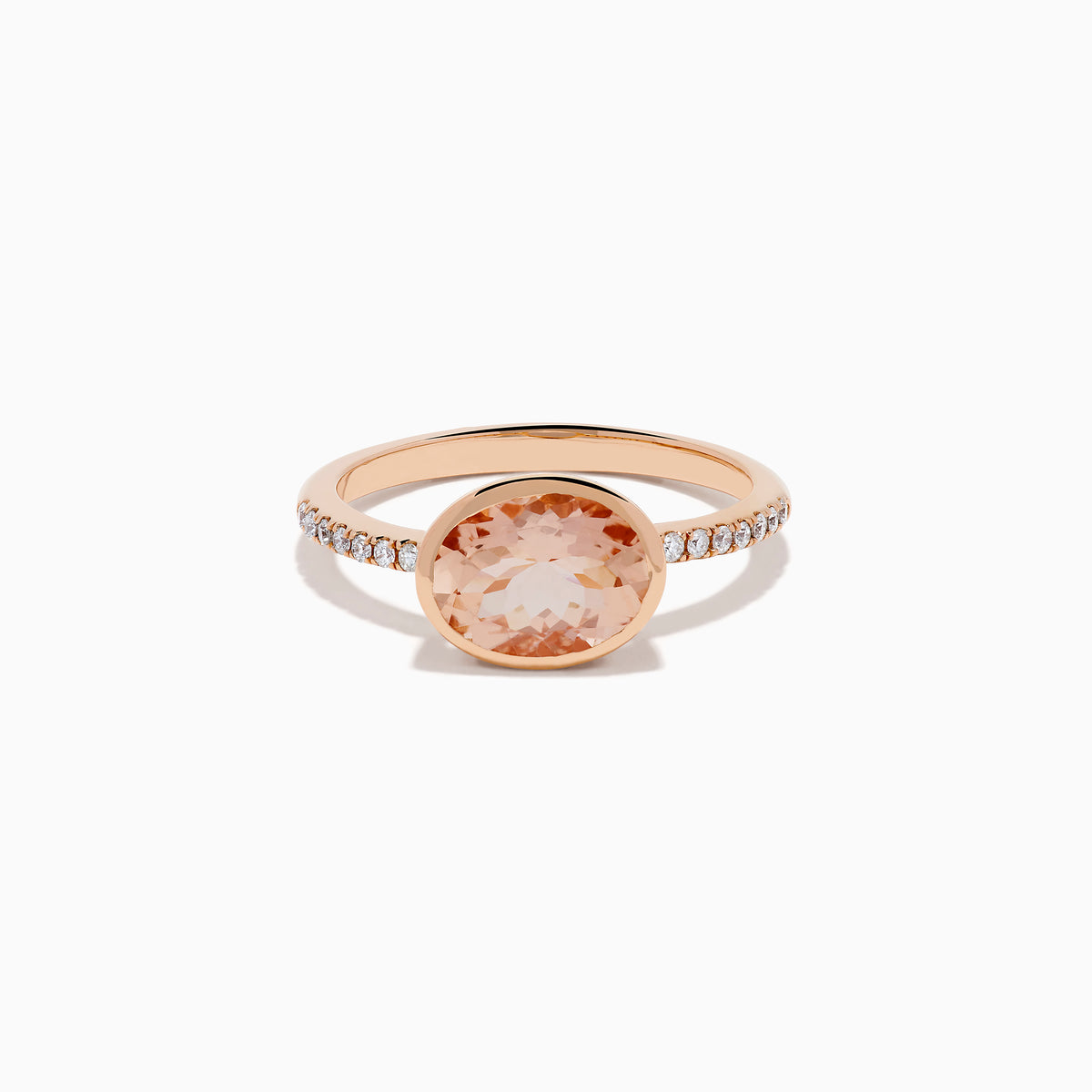 The 14K Rose Gold Morganite and Diamond East West Bezel Ring showcases a striking round peach morganite center stone with small diamonds along the band, set against a white background.