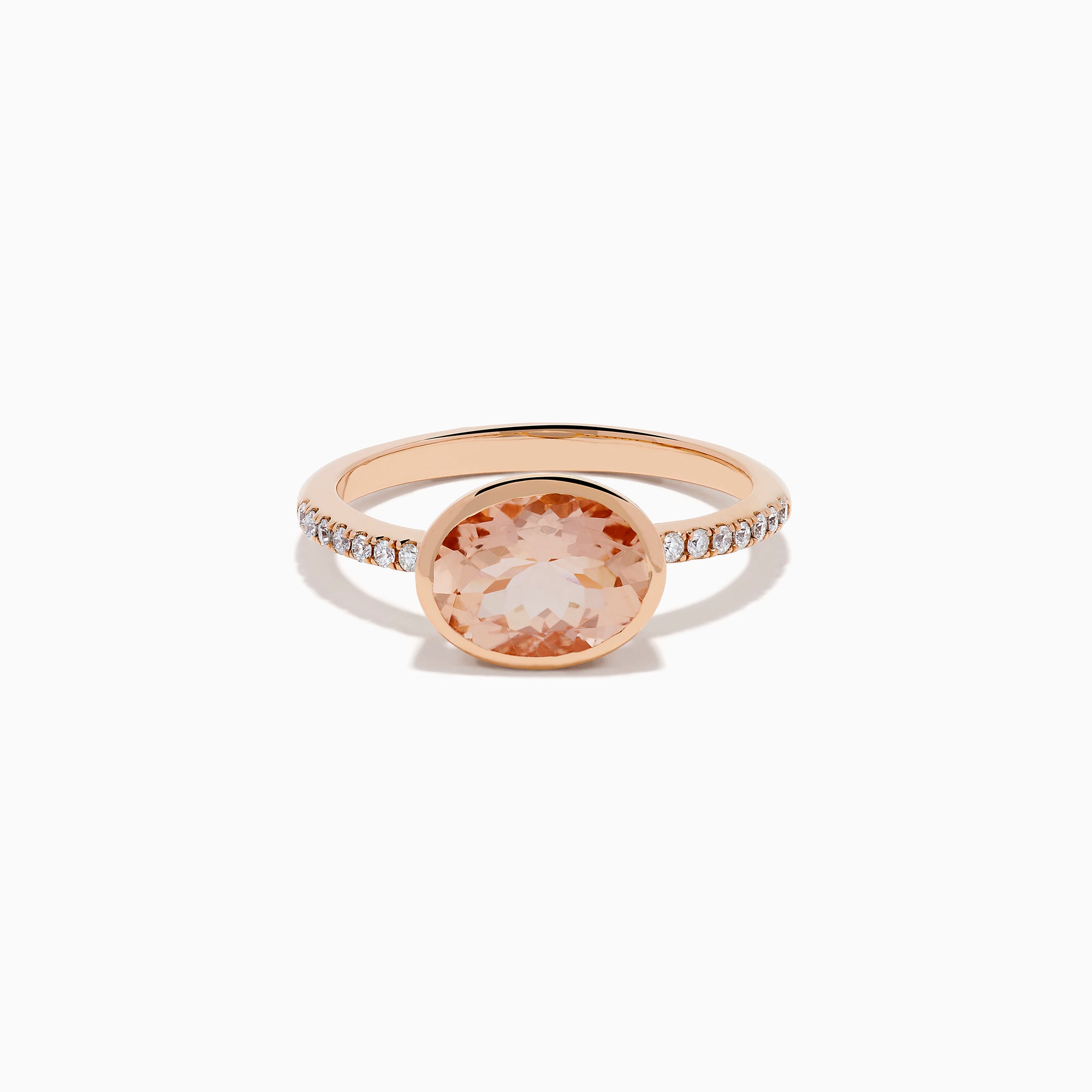 The 14K Rose Gold Morganite and Diamond East West Bezel Ring showcases a striking round peach morganite center stone with small diamonds along the band, set against a white background.