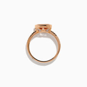The 14K Rose Gold Morganite and Diamond East West Bezel Ring showcases a striking round peach morganite center stone with small diamonds along the band, set against a white background.