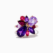 The 14K Rose Purple and Pink Amethyst, Rhodolite, and Pink Tourmaline Ring features a floral design with teardrop and marquise-shaped gemstones arranged as petals on a white background.
