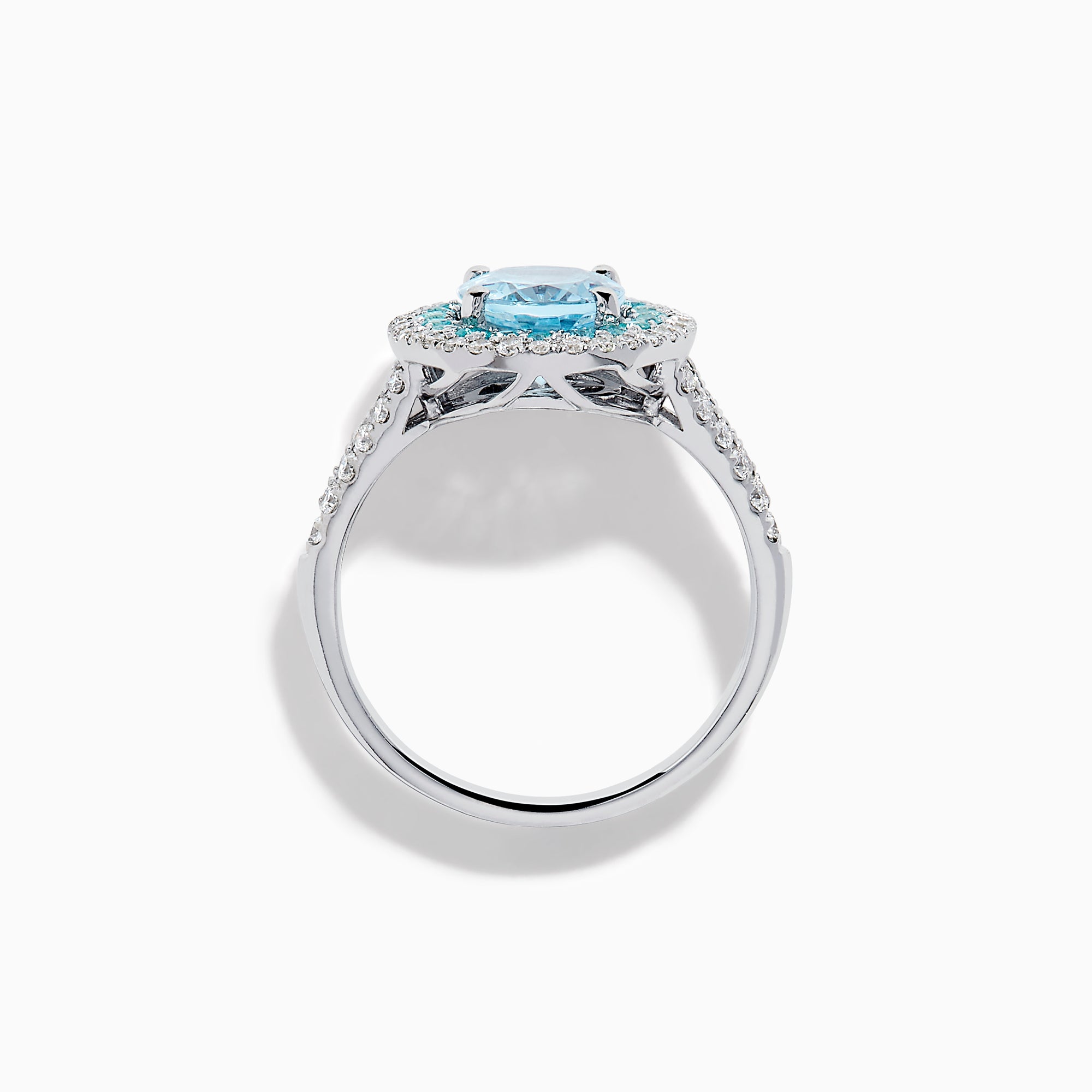 The Aquarius 14K White Gold Aquamarine, Paraiba, and Diamond Ring features an oval aquamarine center stone encircled by two halos of sparkling blue Paraiba and clear diamonds, displayed on a plain white background.