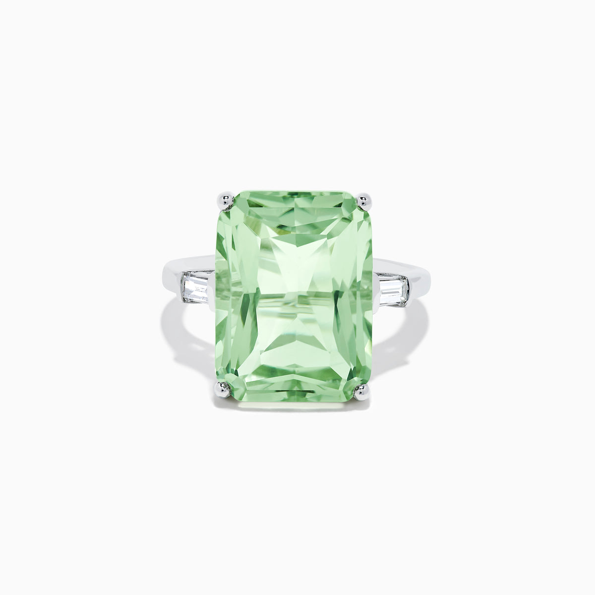 A 14K White Gold Green Amethyst and Diamond 3-Stone Ring features a rectangular, faceted green amethyst center with two small side diamonds, set in white gold and displayed against a white background.