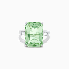 A 14K White Gold Green Amethyst and Diamond 3-Stone Ring features a rectangular, faceted green amethyst center with two small side diamonds, set in white gold and displayed against a white background.