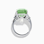 A 14K White Gold Green Amethyst and Diamond 3-Stone Ring features a rectangular, faceted green amethyst center with two small side diamonds, set in white gold and displayed against a white background.