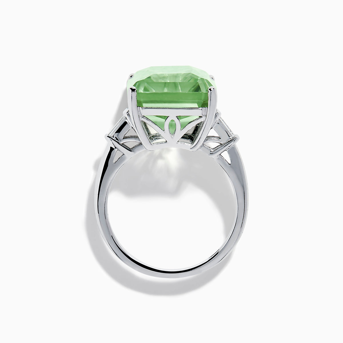 A 14K White Gold Green Amethyst and Diamond 3-Stone Ring features a rectangular, faceted green amethyst center with two small side diamonds, set in white gold and displayed against a white background.