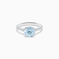 The Aquarius 14K White Gold Aquamarine and Diamond Ring showcases a large oval aquamarine centerpiece with sparkling diamonds along the band, elegantly displayed on a plain white background.
